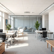 A bright modern office with ergonomic desks, meeting area partitions, and minimalist decor